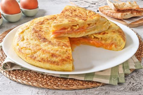 tortilla rellena de verduras y jamón en una sartén