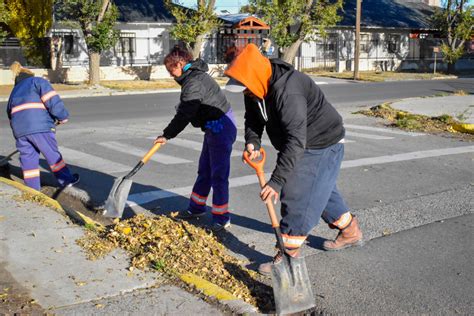 Fotografía de una empleada de limpieza urbana trabajando bajo el sol.