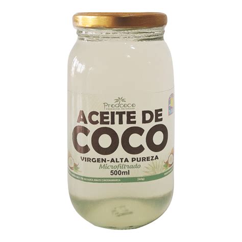 Imagen de un frasco de aceite de coco virgen con cocos frescos al lado.